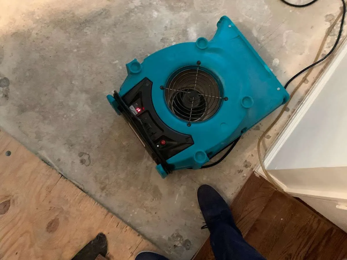 Air mover drying subfloor during Commercial Water Damage Restoration in Gatesville